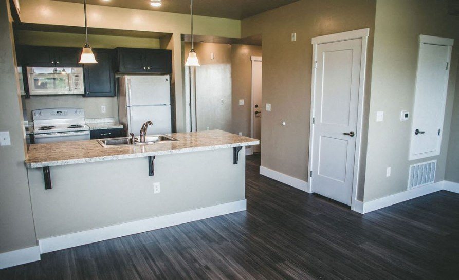 a kitchen with a sink a stove and a refrigerator